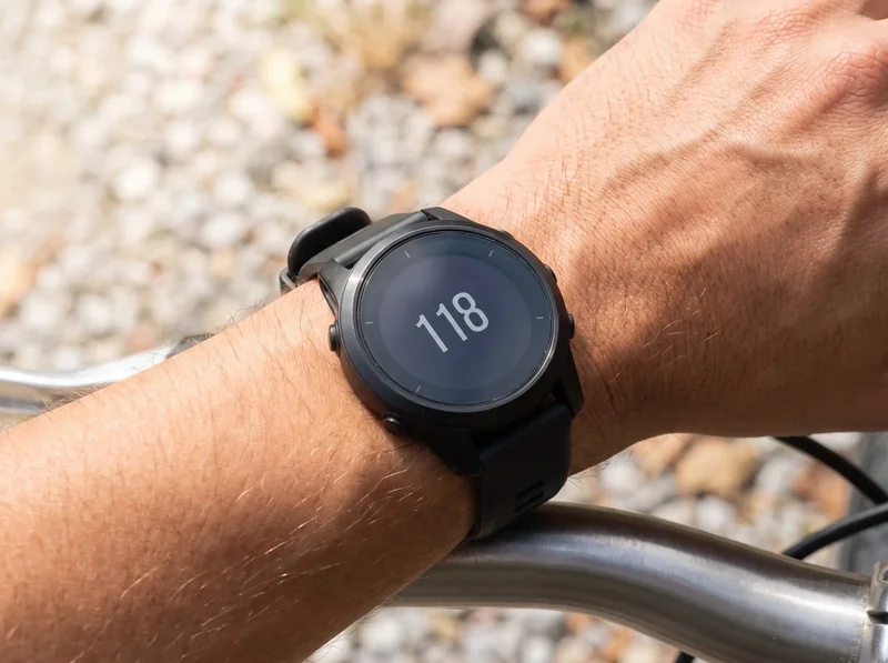 Close-up of heart rate monitor on wrist showing zone 2 training heart rate during exercise